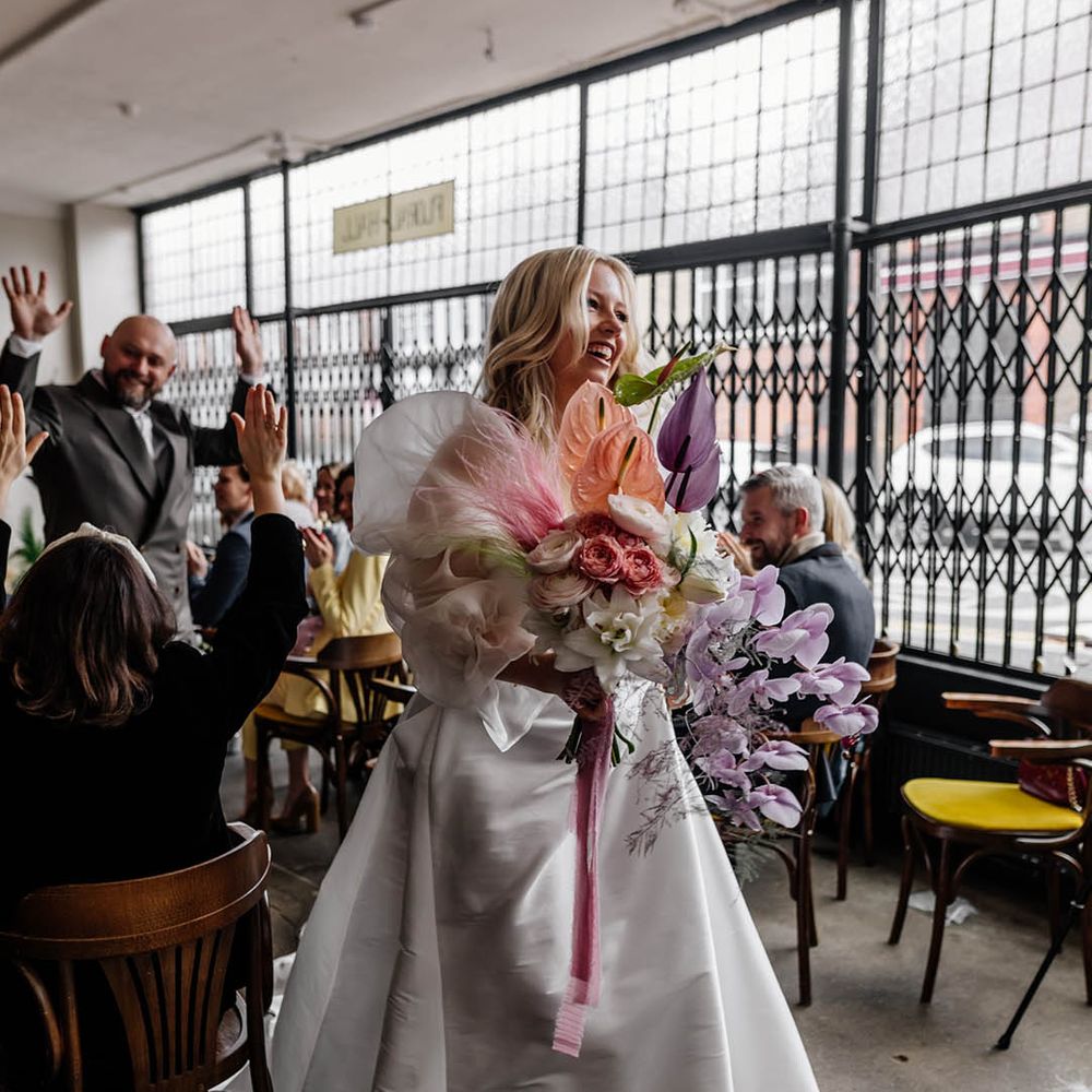 Pastel pink, white and lilac wedding bouquet with orchids, anthuriums, ranunculus and roses
