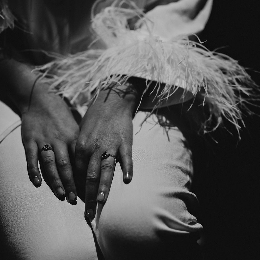 Bride in white pyjamas with feather cuffs