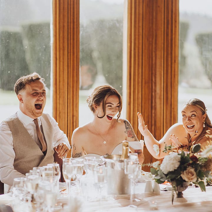 bride & groom laugh during wedding reception speeches at St Audries Park