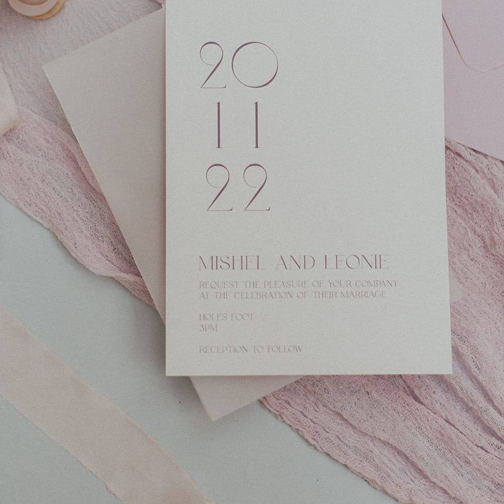 Minimalistic style wedding invitation with simple lilac lettering on white paper