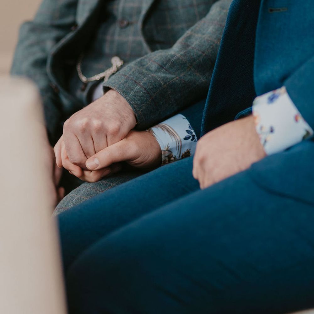 Grooms wear tartan suit and blue suit complete with floral shirts for wedding in Kew Gardens 
