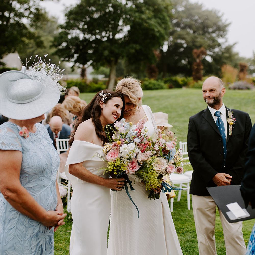 Two brides for their lesbian wedding and outdoor ceremony during summer 