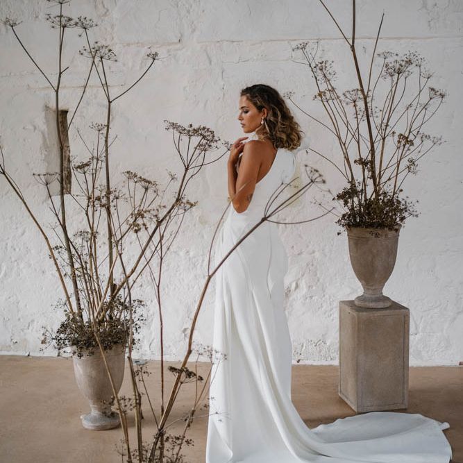 dried flower arrangements and bride in one shoulder dress by Emmy Shoots 
