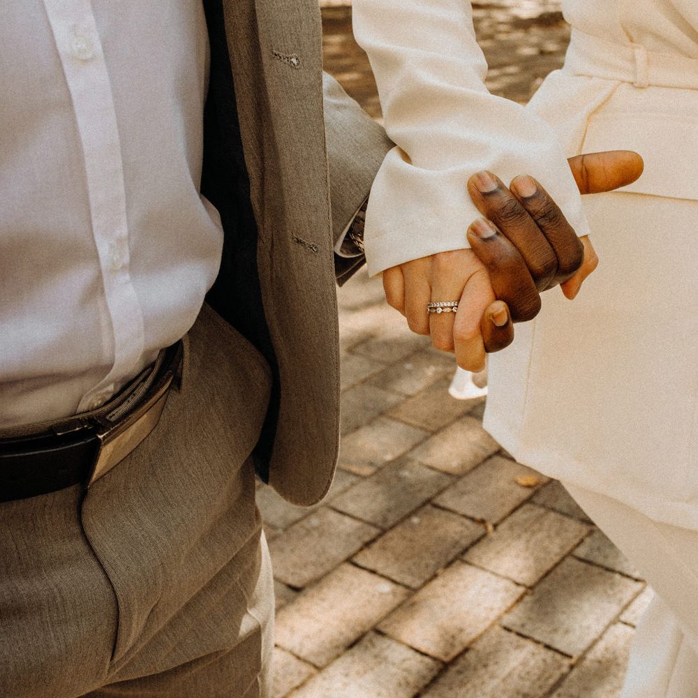 Bride and groom holding hands at Portsmouth Guidhall city elopement 