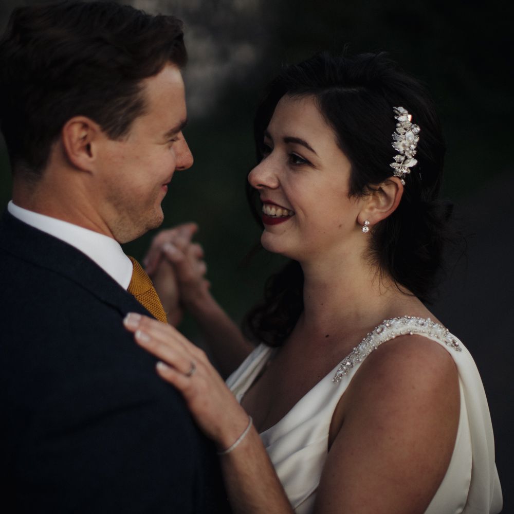 Bride & groom dance together outdoors