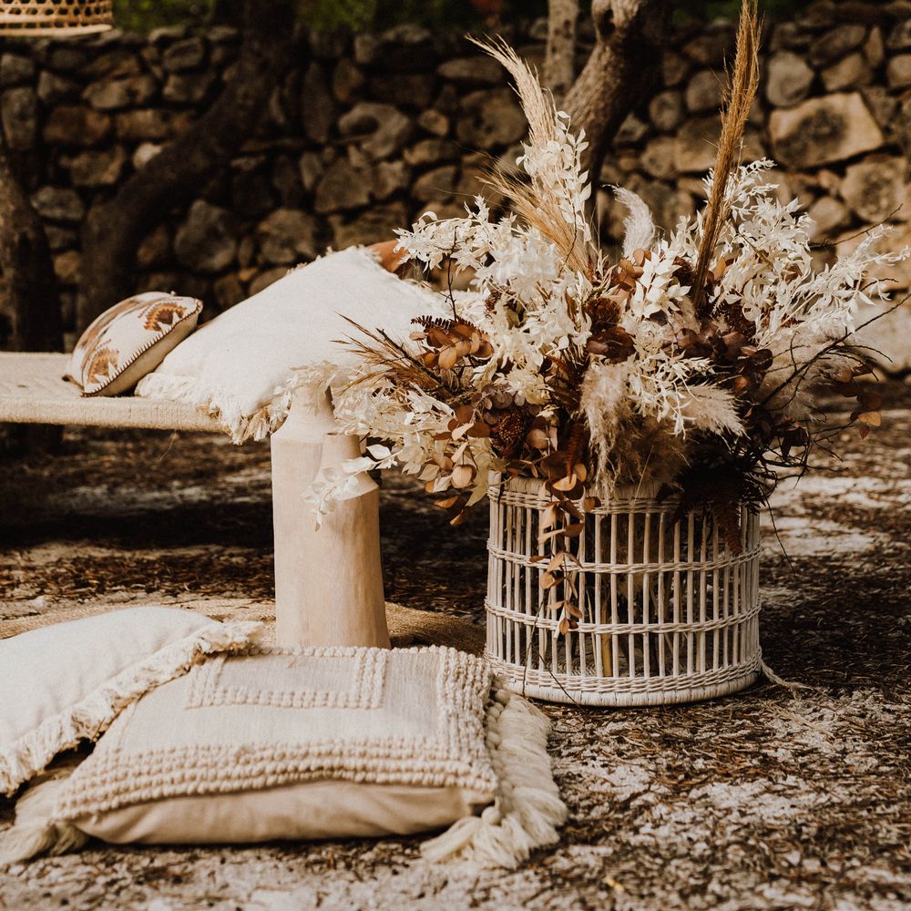 Wicker lampshades with bouquets of pampas grass in a white wicker basket