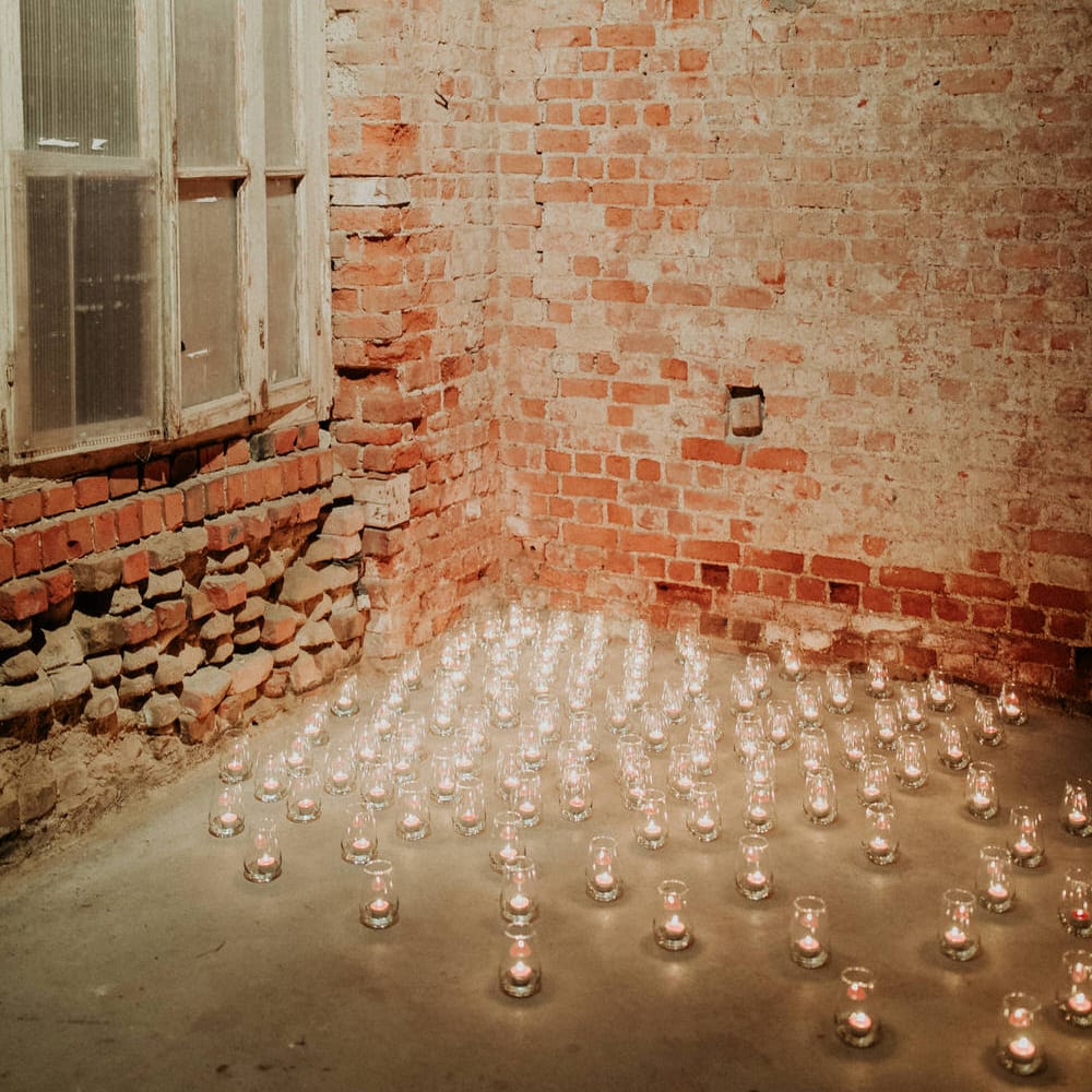 250 tea light candles decorated the entrance, illuminating the exposed brickwork at Block 33