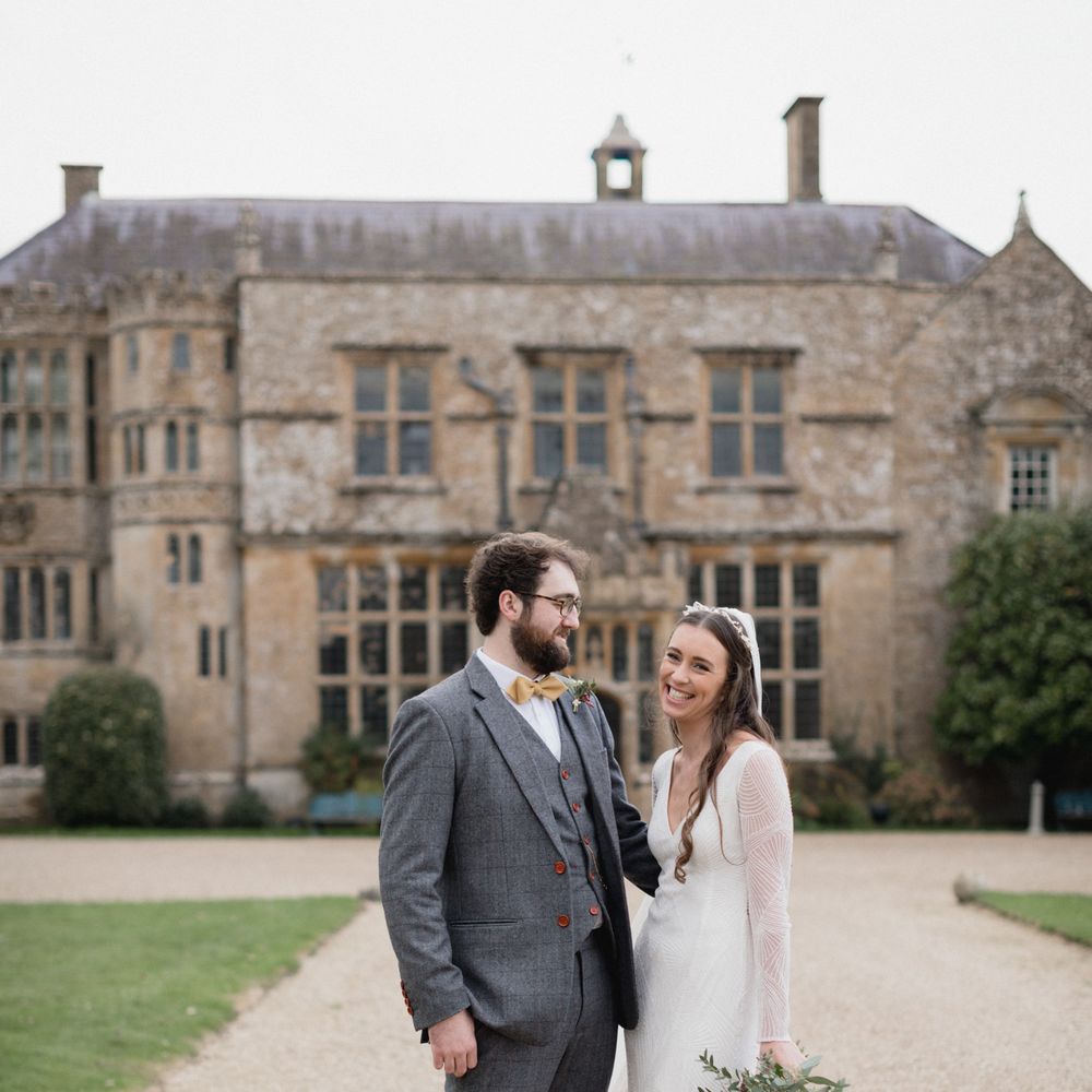 Bride and groom outside Brympton House on their wedding day 