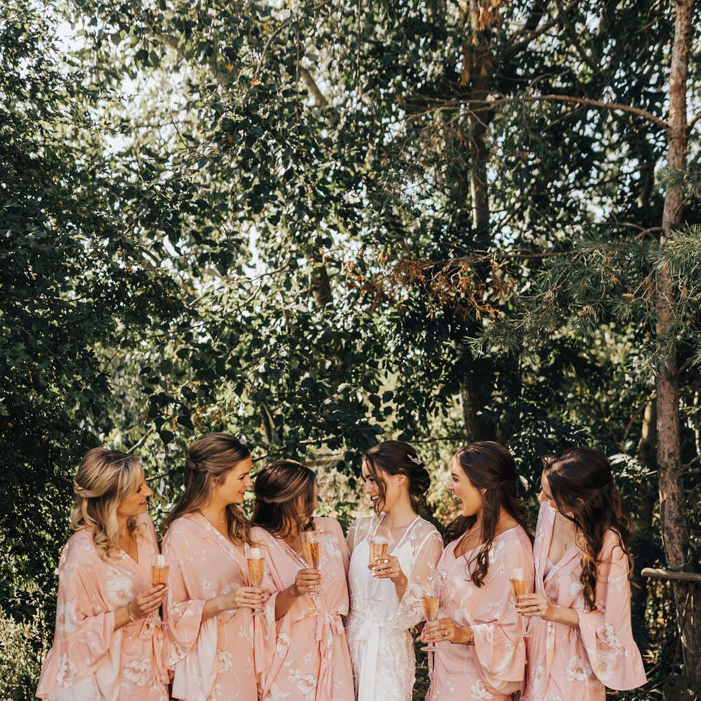 Bride & Bridal party in their blush pink floral bridal robes 
