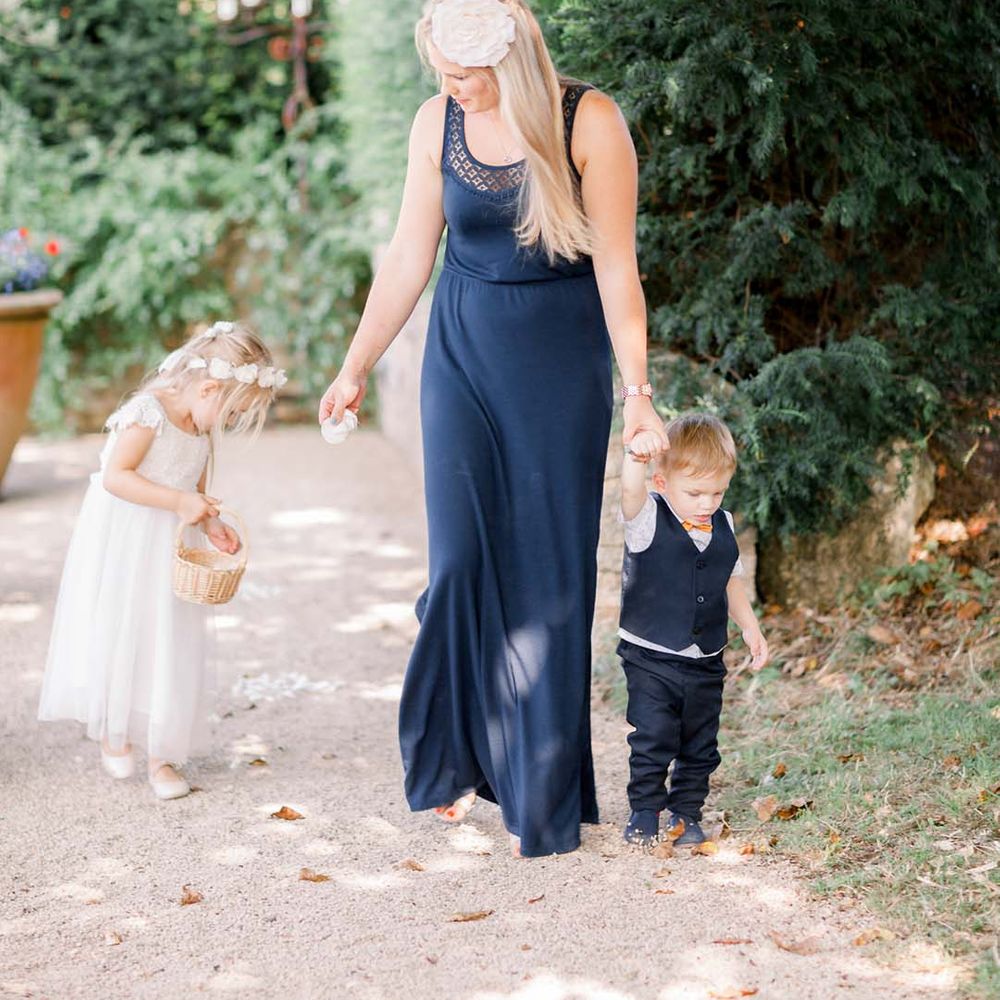 Wedding guest walks with children outdoors 