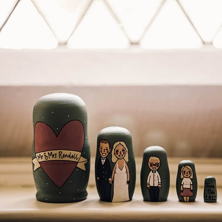 Matryoshka style dolls handprinted to represent the newlyweds and their children 