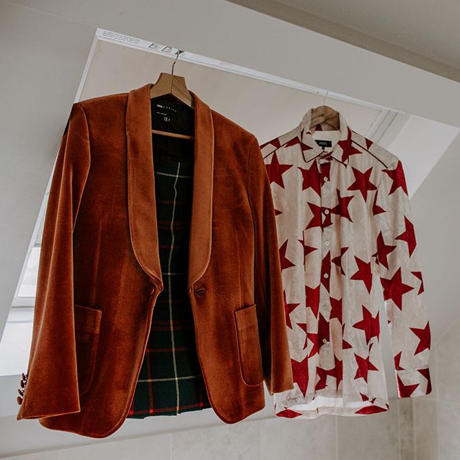 Orange velvet blazer next to colourful white and red star shirt 