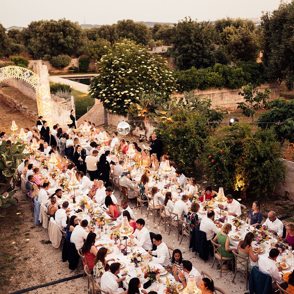 Eagle eye view of the wedding reception with banquet tables, chandelier installations, disco balls for the destination wedding 