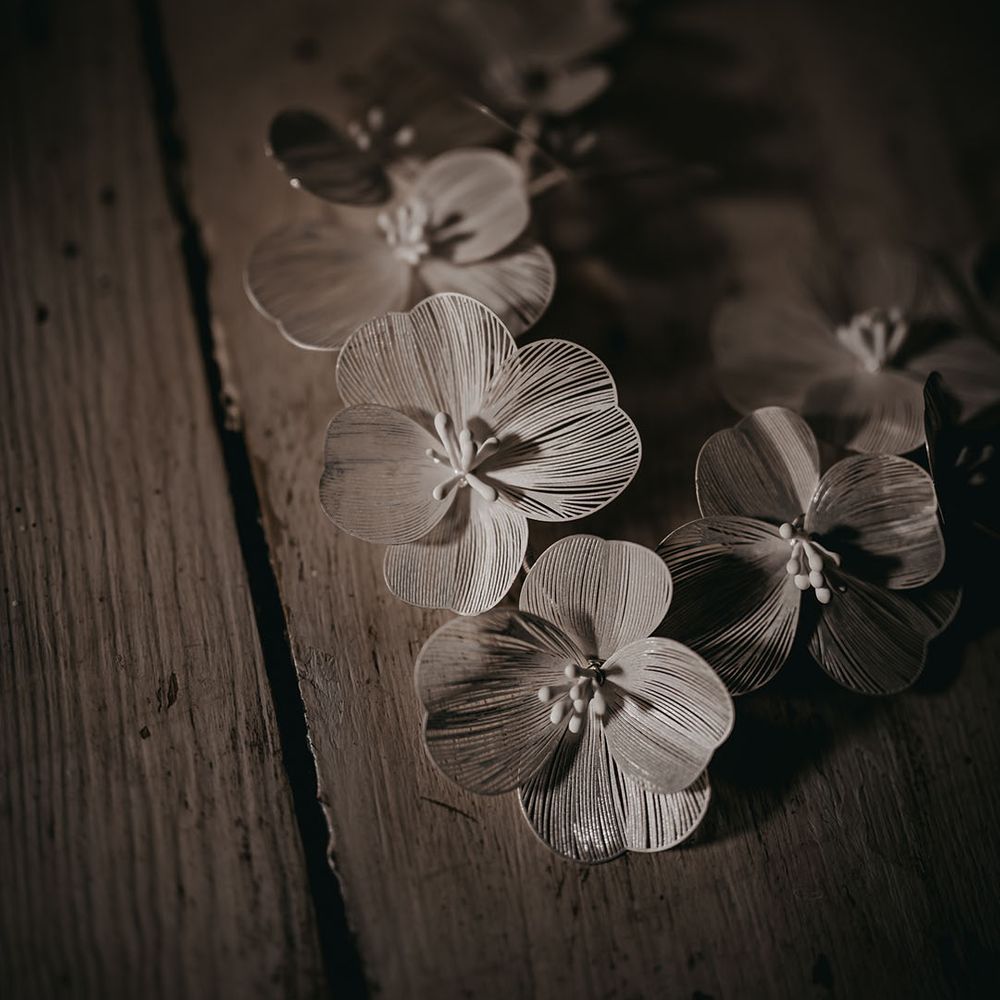 White flower hairpiece for the bride to match her wedding dress