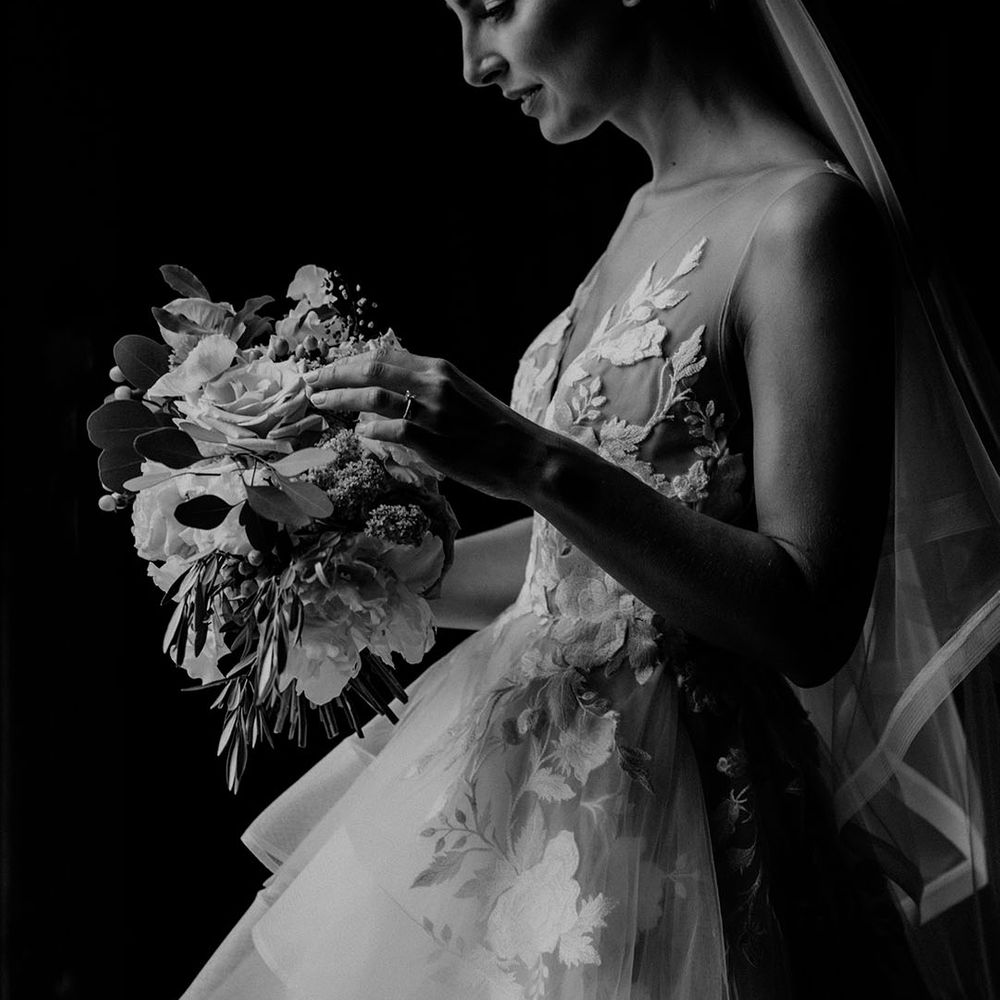 Bride wearing a flower hairpiece from The Bobby Pin and a flower tulle wedding dress 