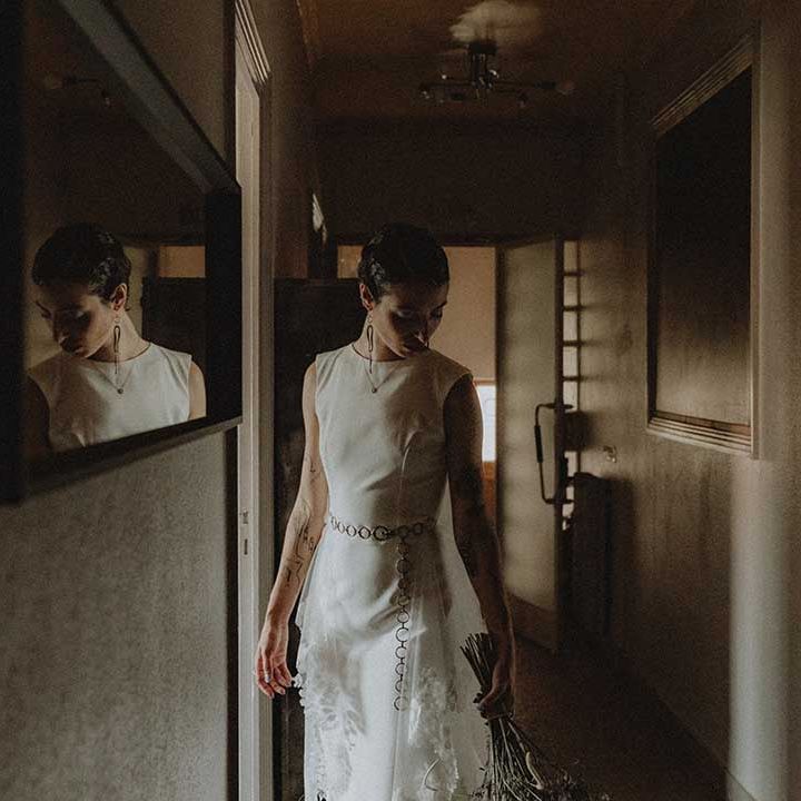 Lisa wears pre loved fitted wedding dress with chain styled belt to the waist 