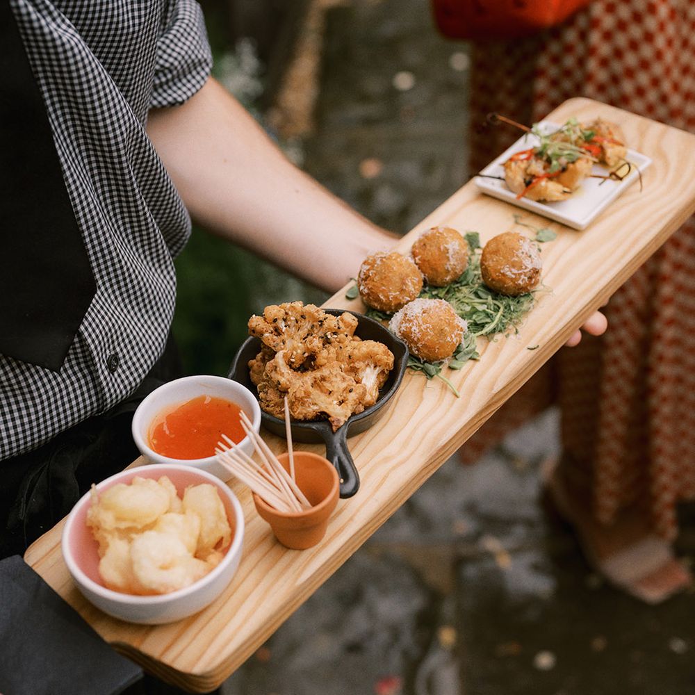Wedding canapés with cauliflower, arancini balls, and prawns with chilli sauce and tooth picks 