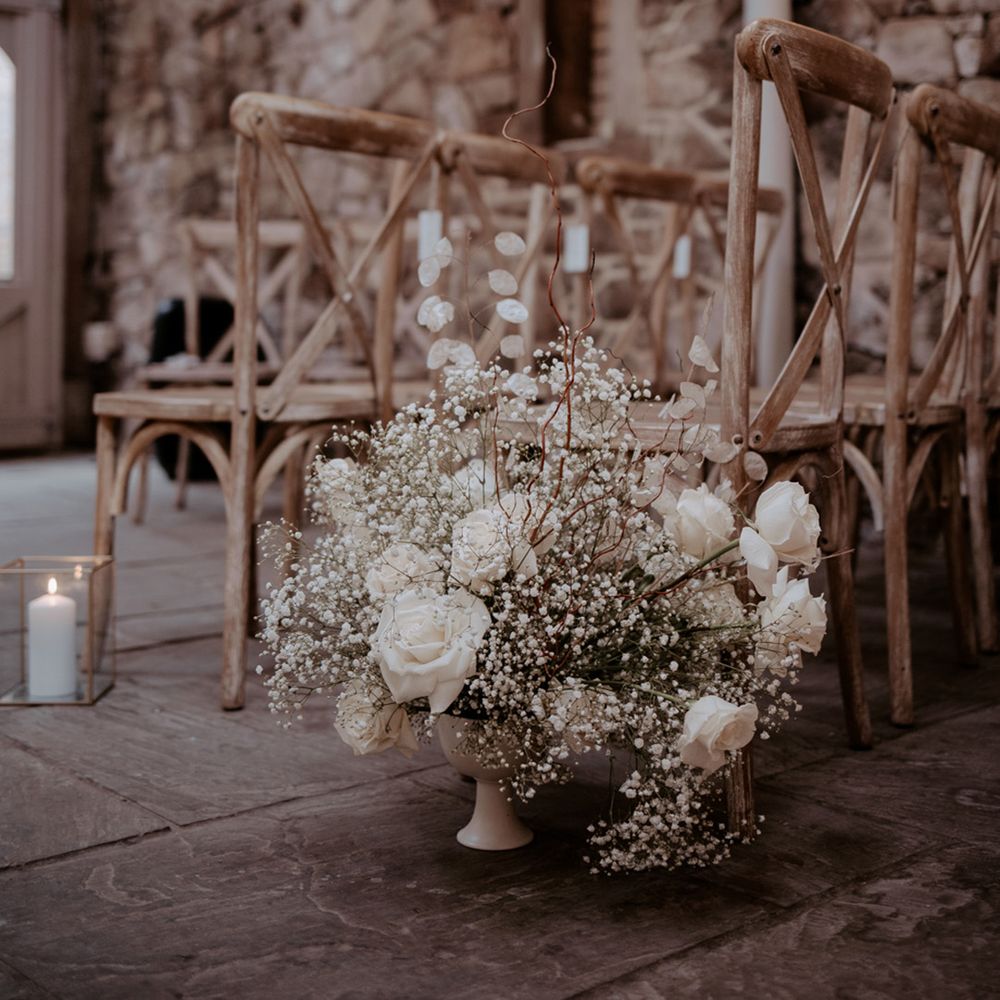 White rose and gypsophila wedding aisle flowers with candles for classic wedding 
