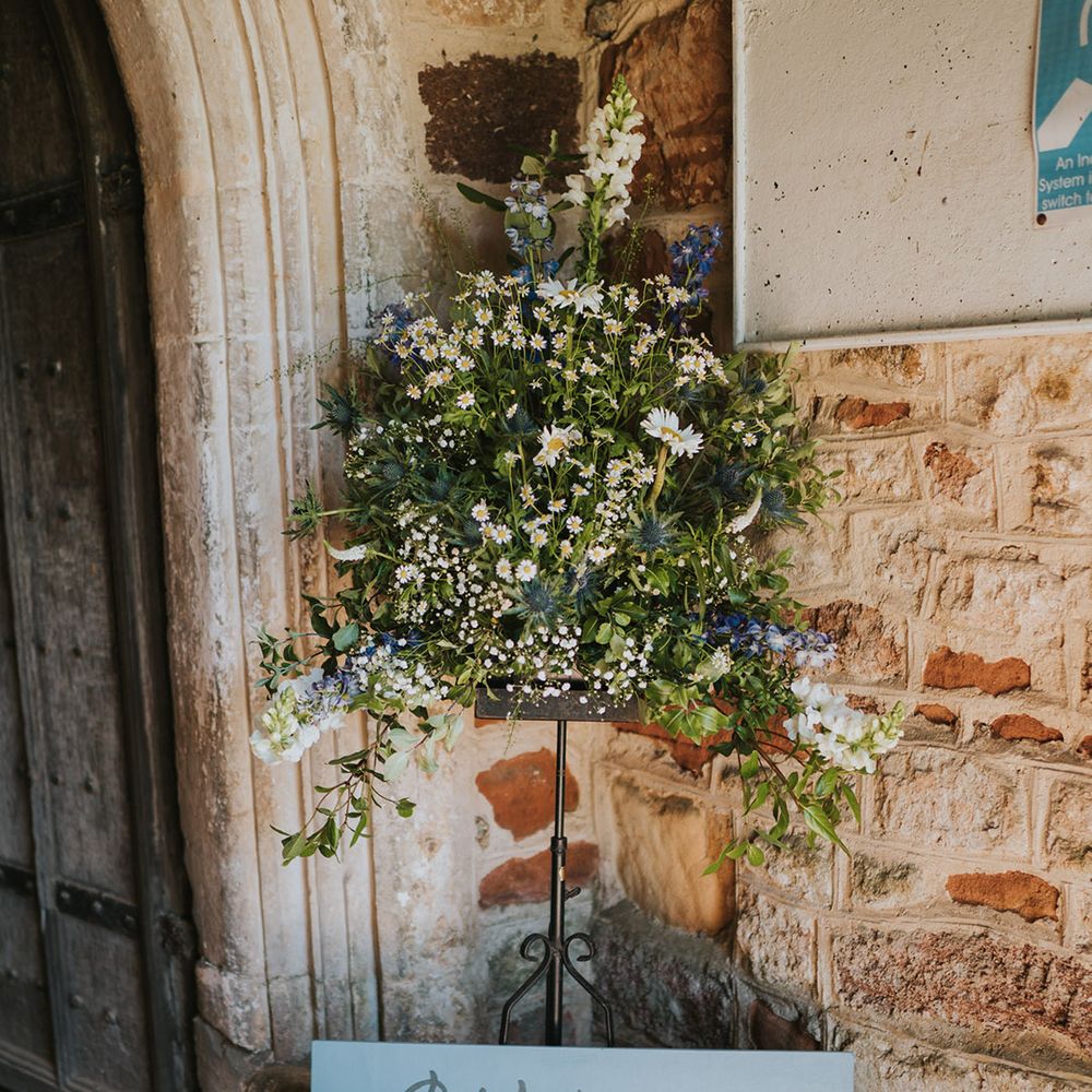 Blue wedding welcome sign with daisy wedding flowers 