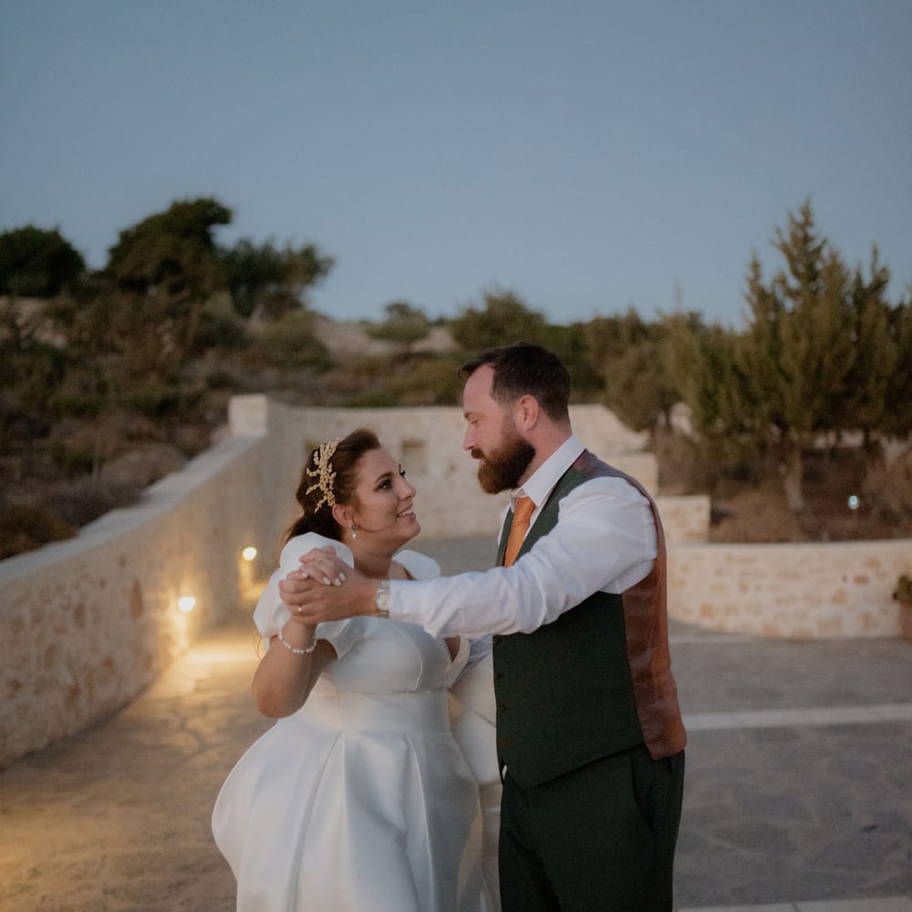 Bride and groom dancing during dusk at private villa wddding in Paros, Greece