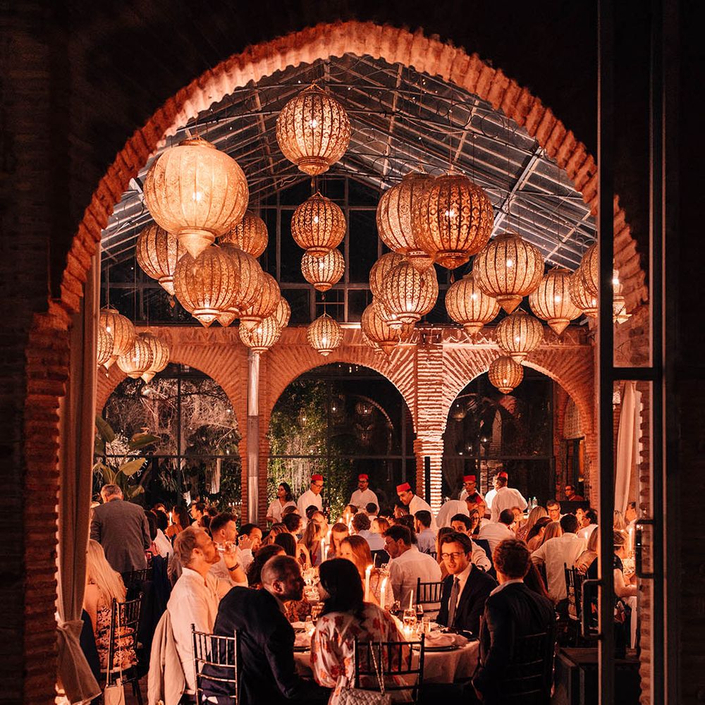 Beldi Country Club wedding venue with the guests seated for the wedding breakfast with golden lanterns 