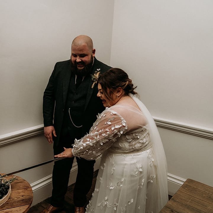 The bride and groom cut their cheese tower instead of wedding cake 