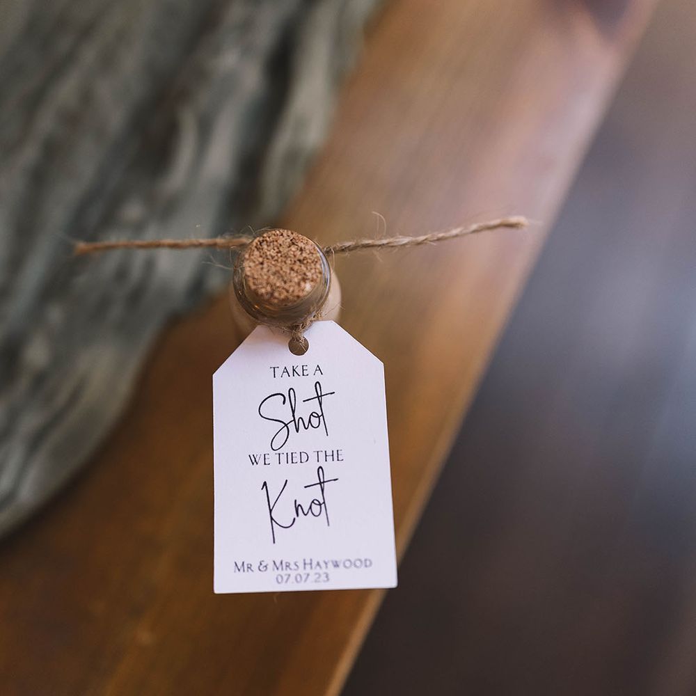 Baby Guinness shot wedding favours with white tag attached 