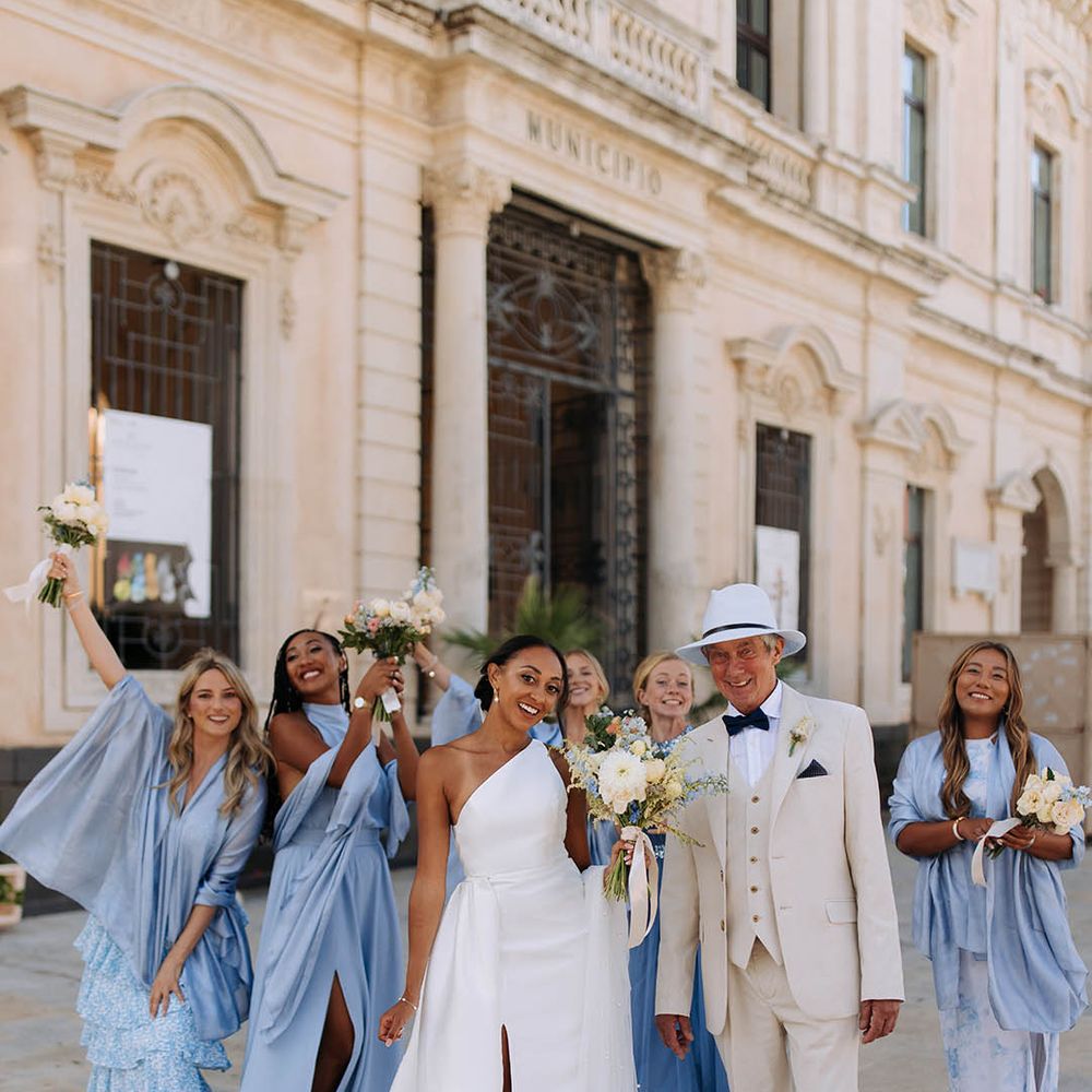 Bridal party wearing pale dusty blue bridesmaid dresses at destination wedding 
