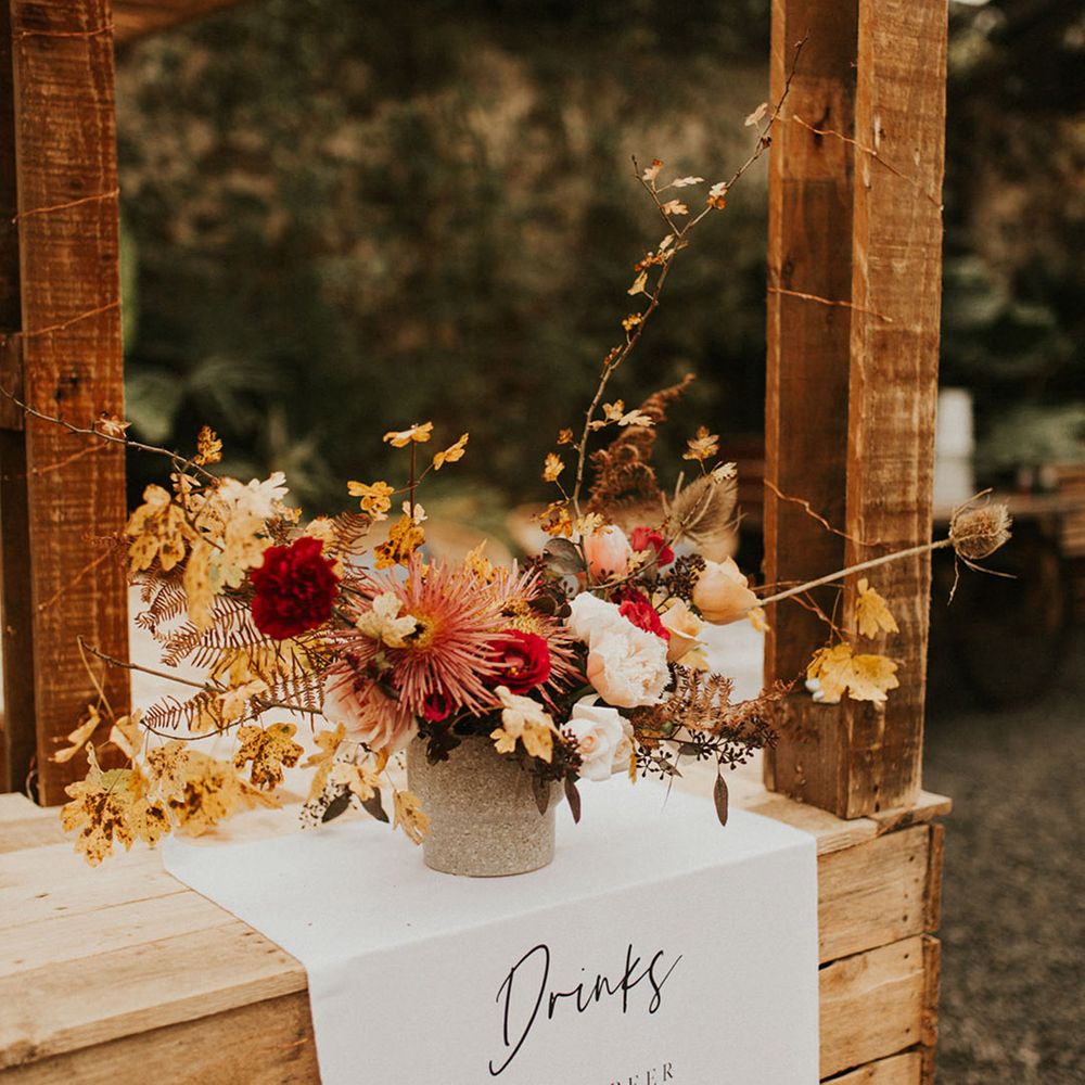 Autumnal rustic themed wedding bar design idea with dried wedding flowers and fabric menu sign 