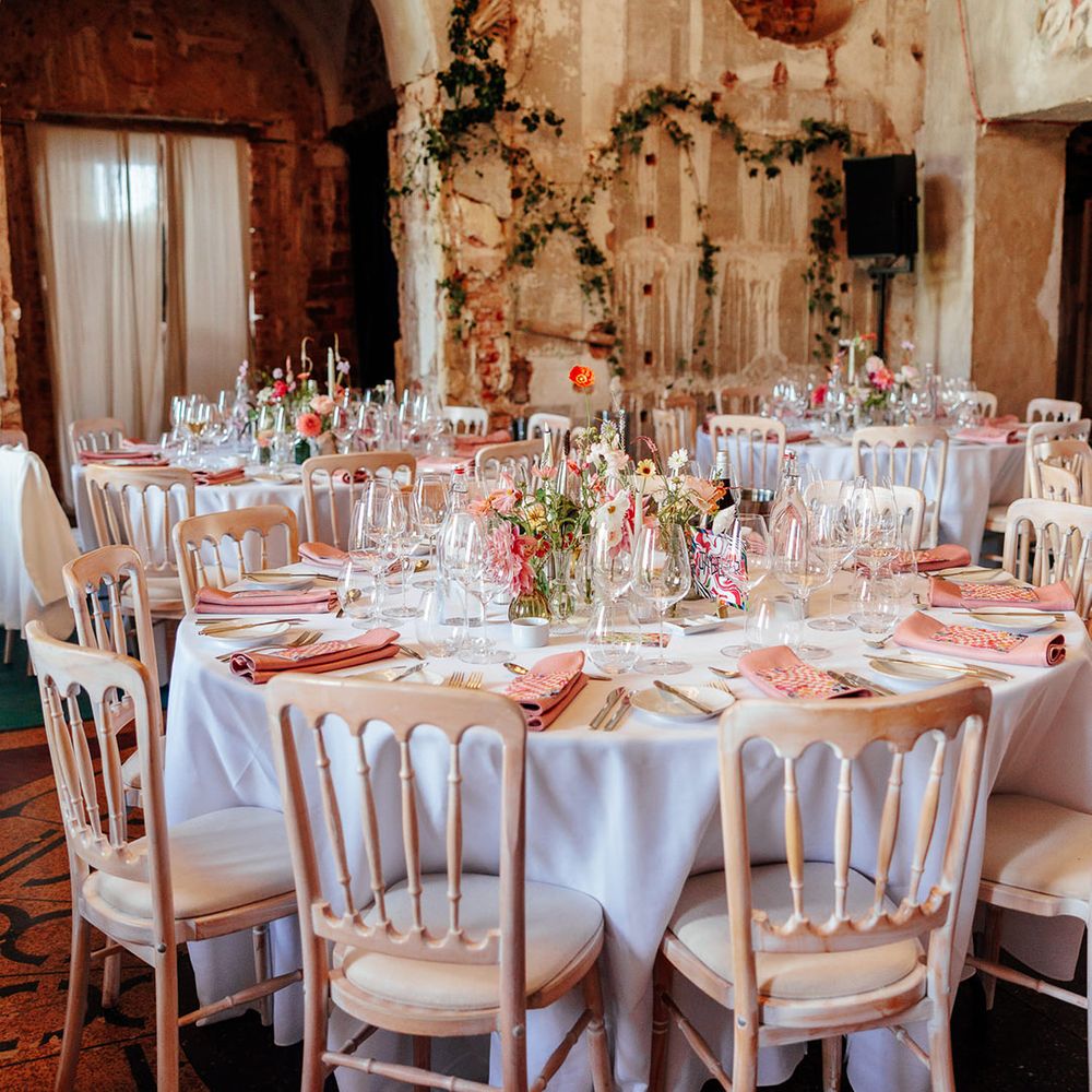 Pink wedding table decor and flowers with pink napkins and menu stationery 