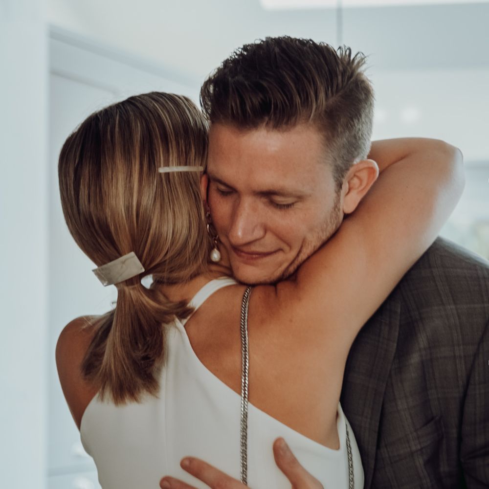 Groom embracing his bride during the first look 