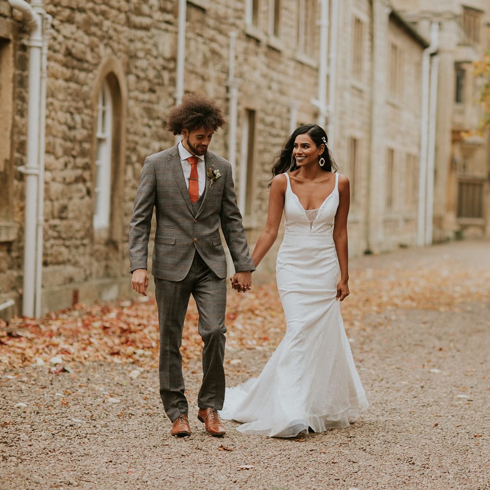 Bride and groom holding hands at Hooton Pagnell Hall 
