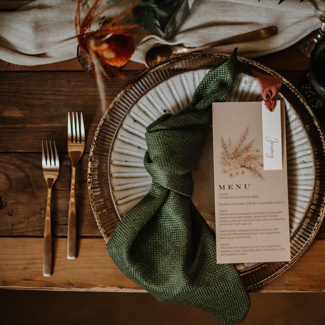 Emerald green and orange wedding table with gold cutlery