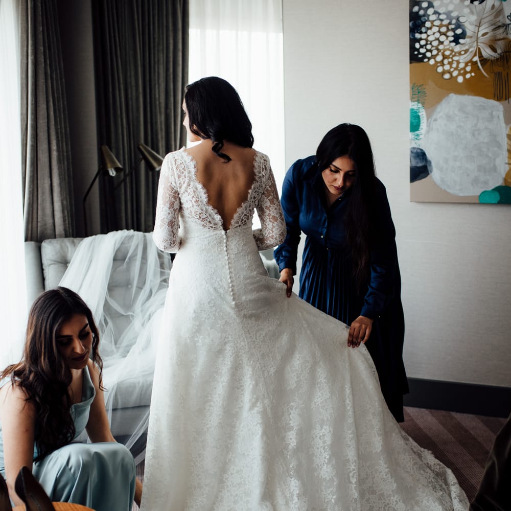 Bride wears white wedding gown from Pronovias with low back and lace bodice