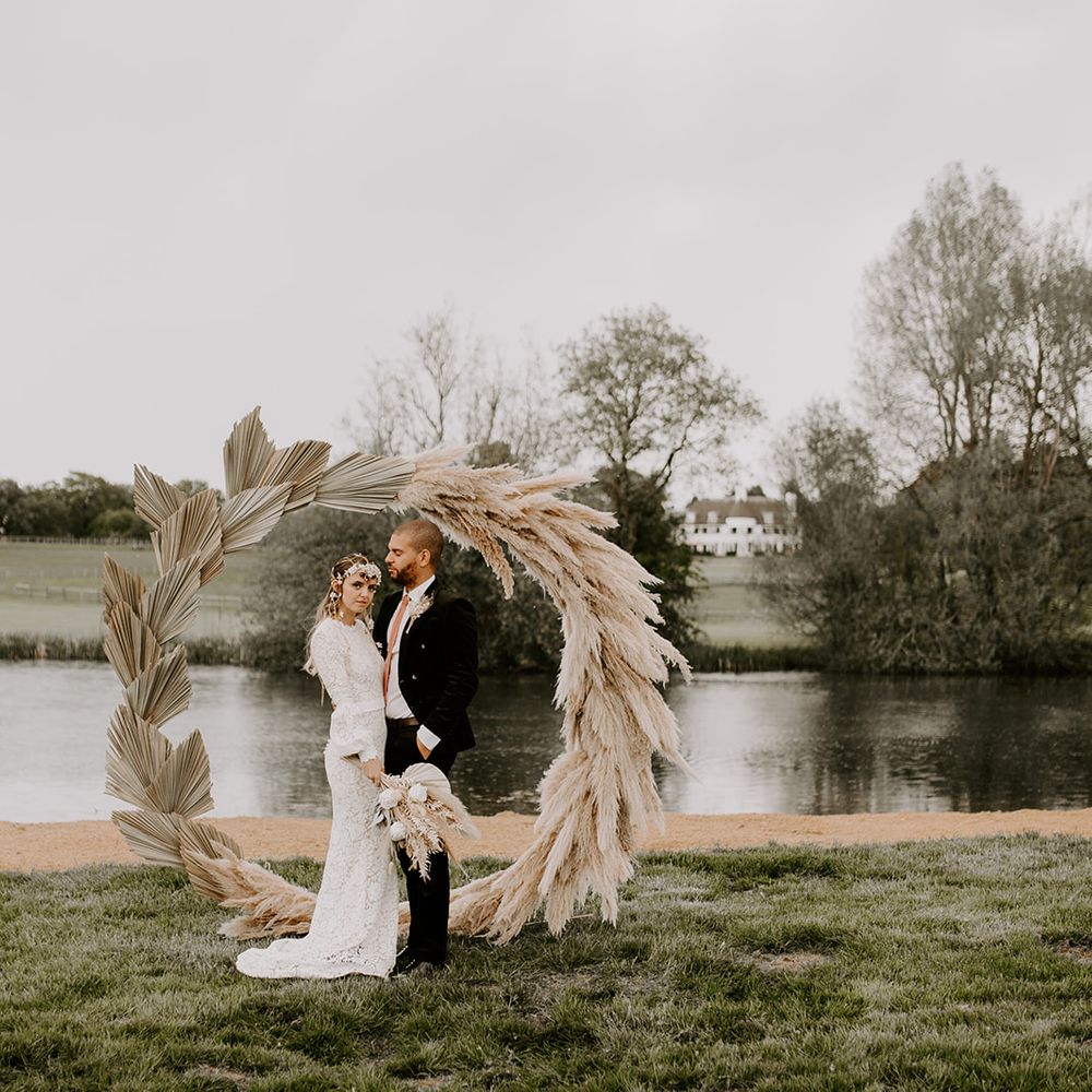 Dried palm lead and pampas grass moon gate arch for boho wedding at Waresley Park Estate 