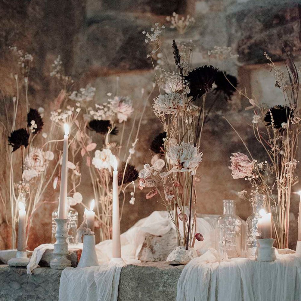 glass bottles with calligraphy, candles and dried flower stem wedding decor 