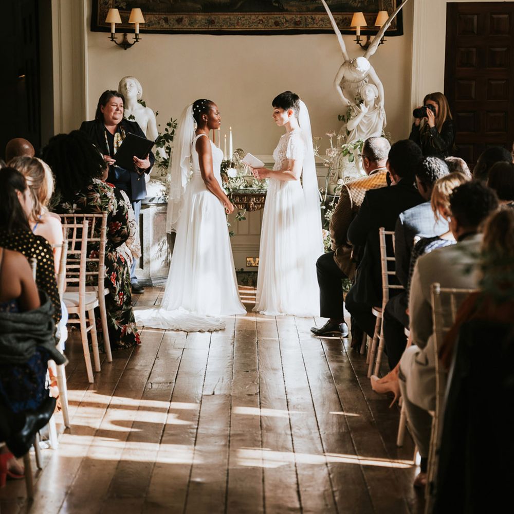Bride and bride exchanging vows at their same sex civil wedding ceremony at Elmore Court wedding venue 