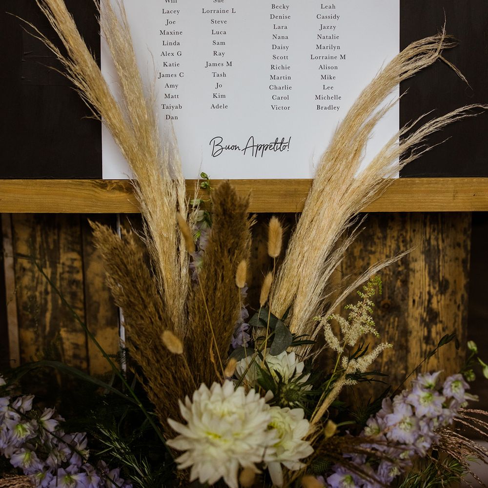Personalised seating chart for wedding with dried and fresh flower decorations