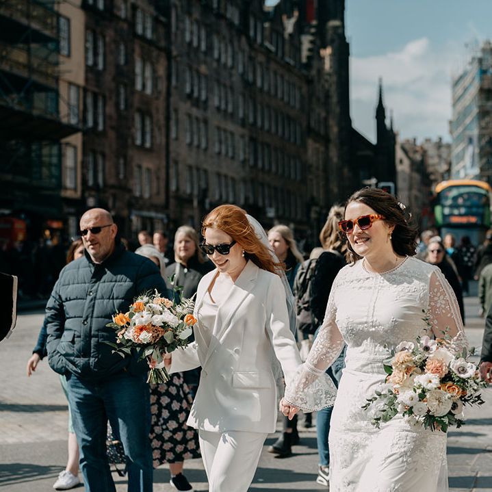 Brides walk the Royal Mile on their wedding day in Edinburgh 