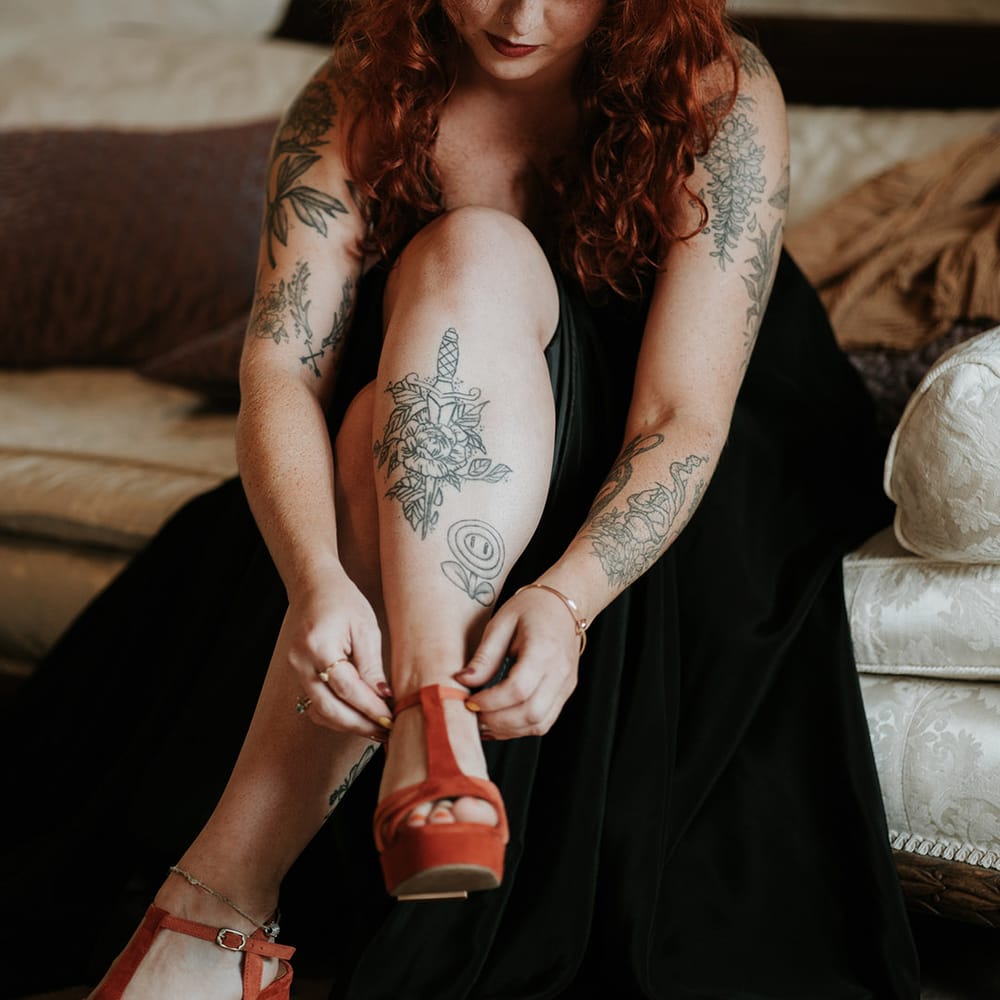 Bride in black wedding dress and burnt orange velvet open toe wedding shoes 