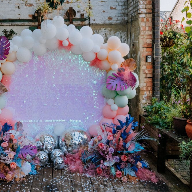 Altar back drop with sequin sheet, balloon installation and glitter balls 