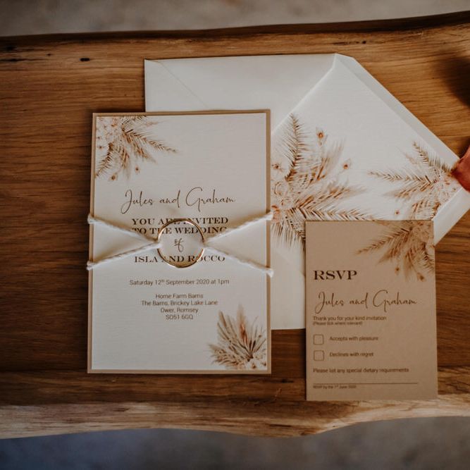 Rustic wedding stationery with pampas grass decoration with orange ribbon