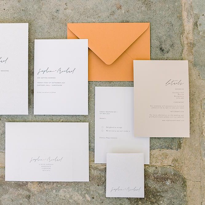 Contemporary wedding stationery suite with script font and orange envelope 