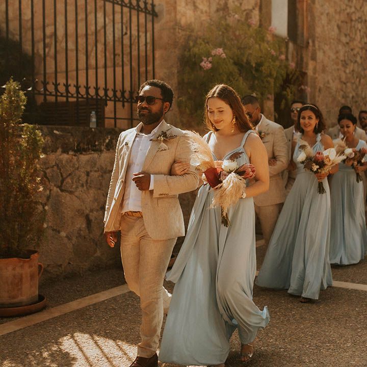 Bridesmaids prepare to walk down the aisle with groomsmen