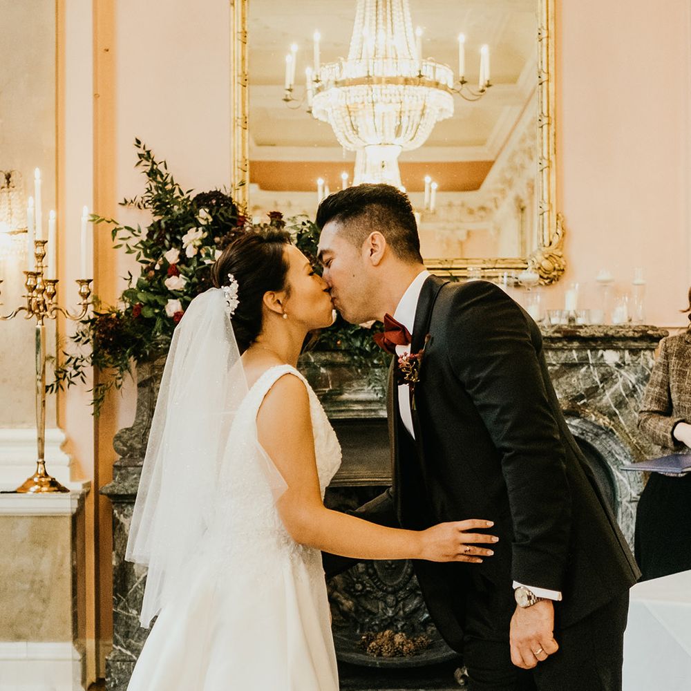 Bride and groom kiss at Danesfield House wedding ceremony