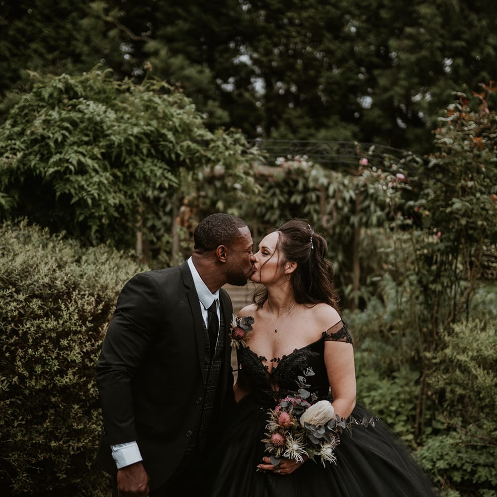 Bride & groom lean into kiss on their wedding day