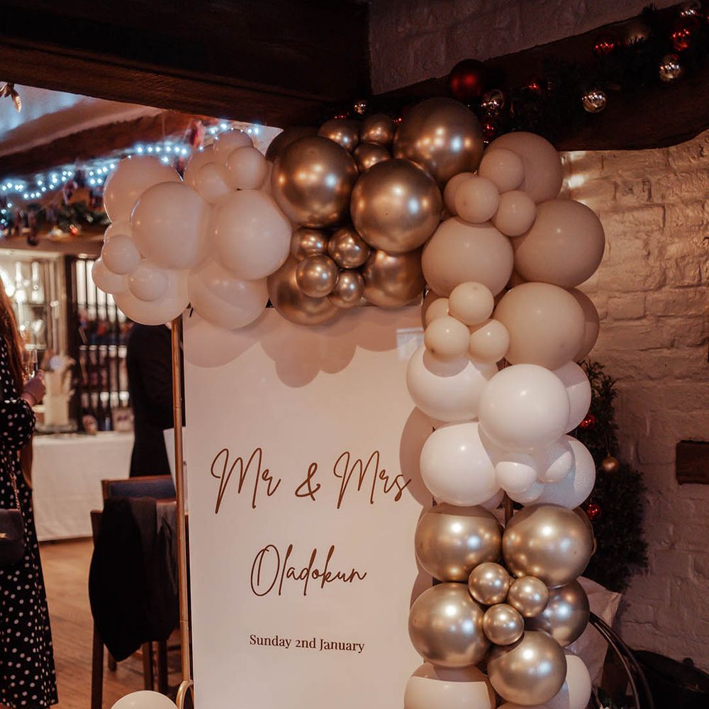 Gold and white balloon arch for wedding reception 
