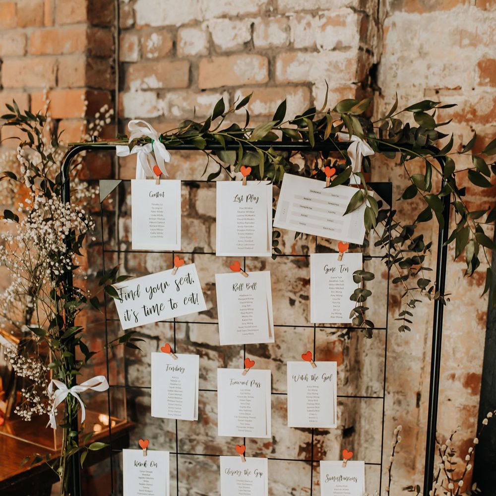 Industrial style wedding table plan with wire frame and heart shaped pegs decorated with foliage for wedding at Scale in Liverpool