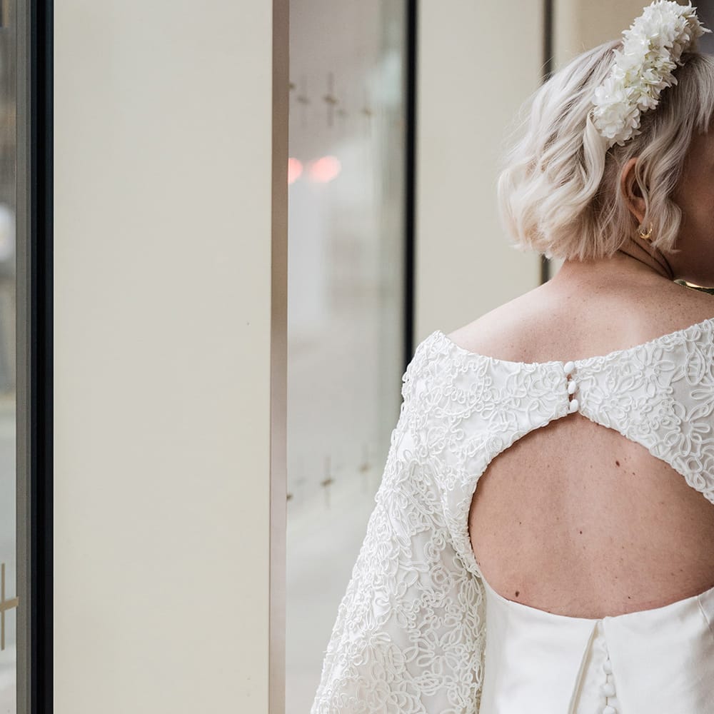 Bride in short wedding dress with cut out back detail and buttons