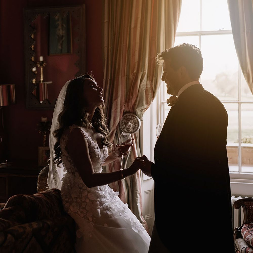 Bride and groom enjoy a moment alone with some wine after their wedding ceremony 